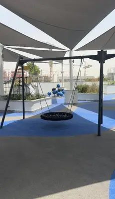 a stage with a white tent with a swing at Superb 1BR high floor apartment on Sobha Hartland in Dubai