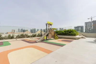 a playground on the roof of a building at Elegant Designer Studio with Balcony & Rooftop Pool in JVC in Dubai