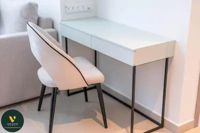 a white desk and a chair next to a couch at Vogue Downtown Act One near Burj Khalifa and Dubai Mall, Two Bedroom Apartment with Balcony and City Skyline View, Access to all Amenities in Dubai