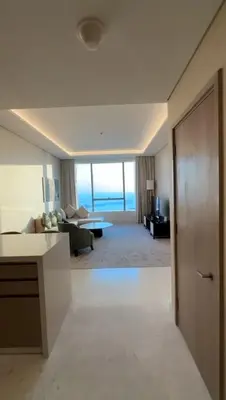 a living room with a couch and a table in a room at PALM TOWER by Design Studio 1 BR in Dubai