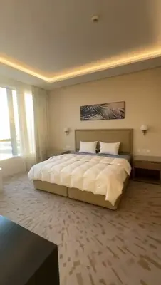 a bedroom with a large bed with white sheets at PALM TOWER by Design Studio 1 BR in Dubai