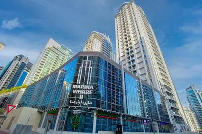 a large glass building in a city with tall buildings at Stunning 2 Bedroom Apartment in JBR with Balcony in Dubai