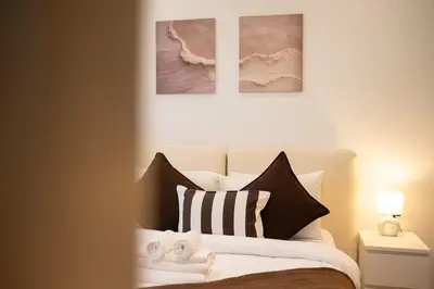 a bedroom with a bed with two pictures on the wall at Luxury 1 Bedroom - Burj Khalifa & sea view - Sauna & Pool - High Floor in Dubai