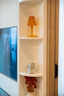 a lamp sitting on a shelf next to a tv at Luxury 1 Bedroom - Burj Khalifa & sea view - Sauna & Pool - High Floor in Dubai