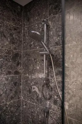 a shower with a shower head in a bathroom at Luxury 1 Bedroom - Burj Khalifa & sea view - Sauna & Pool - High Floor in Dubai