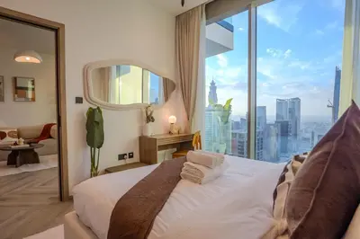 a bedroom with a bed with a large window at Luxury 1 Bedroom - Burj Khalifa & sea view - Sauna & Pool - High Floor in Dubai