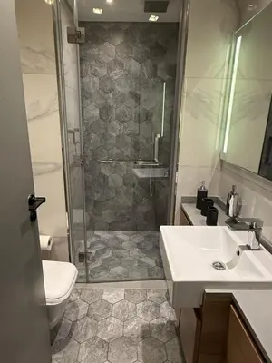 a bathroom with a shower and a sink and a toilet at Mag318 Luxury 5 Minutes to Burj&mall in Dubai