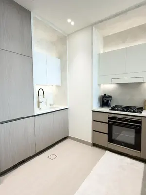 a kitchen with a sink and a stove at Luxe Apt with Private Balcony Pool in Dubai