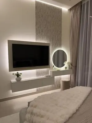 a bedroom with a flat screen tv on a wall at Luxe Apt with Private Balcony Pool in Dubai