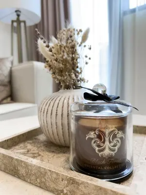 a candle and a vase on a table at Luxe Apt with Private Balcony Pool in Dubai
