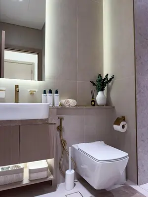 a bathroom with a white toilet and a sink at Luxe Apt with Private Balcony Pool in Dubai