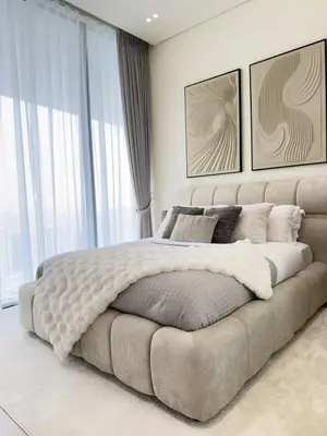 a bedroom with a large bed and a large window at Luxe Apt with Private Balcony Pool in Dubai