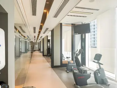 a gym with treadmills and ellipticals in a building at Premium 2BR with Park View in Dubai Creek Harbour in Dubai
