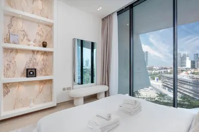 a bedroom with a white bed and a large window at Private pool, Paddle court, Sauna and Hammam - Binghatti Royal in Dubai