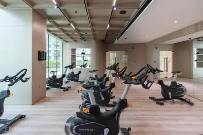 a gym with rows of exercise bikes in a room at Private pool, Paddle court, Sauna and Hammam - Binghatti Royal in Dubai