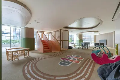 a room with a playground with a table and swings at Private pool, Paddle court, Sauna and Hammam - Binghatti Royal in Dubai