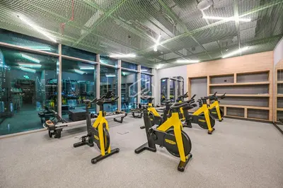 a gym with a bunch of exercise bikes in it at Stylish Studio with views of pool & Burj Khalifa in Dubai