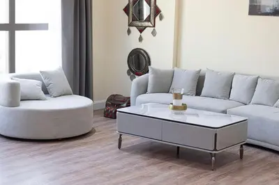 a living room with a couch and a coffee table at Stunning 2BR with Sea View Murjan 1 Near Beach in Dubai