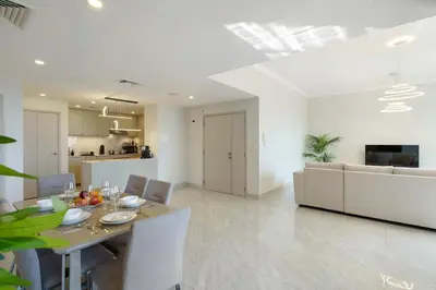a dining room and kitchen with a table and chairs at Modern Upgraded 1BR - High Floor with Ocean View in Dubai