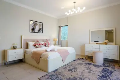 a bedroom with a large bed and a mirror at Modern Upgraded 1BR - High Floor with Ocean View in Dubai