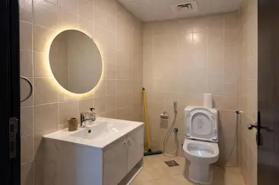 a bathroom with a sink and a toilet with a mirror at 1BR in Dubai Marina with Marina Skyline Views in Dubai