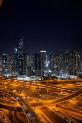a city skyline at night with traffic on a freeway at 1BR in Dubai Marina with Marina Skyline Views in Dubai