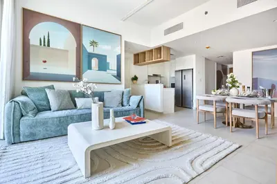 a living room with a couch and a table at Frank Porter - Downtown Views II in Dubai