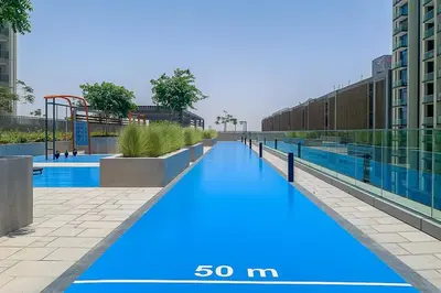 a large swimming pool with blue paint on it at Frank Porter - Downtown Views II in Dubai