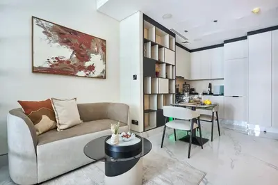 a living room with a couch and a table and a kitchen at Frank Porter - J One Tower, Business Bay in Dubai