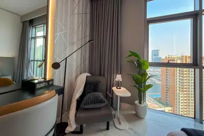 a room with a desk and a chair and a window at Panoramic View Dubai Mall 8 min walk Infinity pool in Dubai
