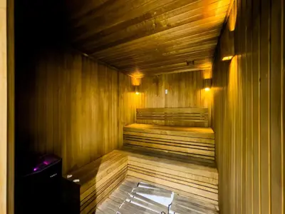 a wooden sauna with a bench in a room at Panoramic View Dubai Mall 8 min walk Infinity pool in Dubai