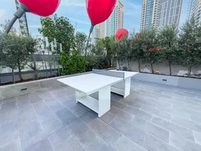 a white table on a rooftop with red balloons at Panoramic View Dubai Mall 8 min walk Infinity pool in Dubai