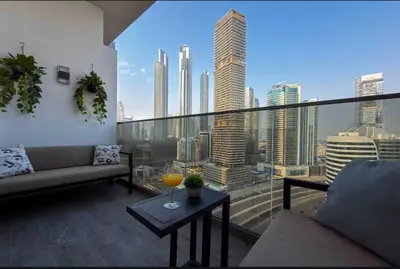 a living room with a view of a city skyline at Panoramic View Dubai Mall 8 min walk Infinity pool in Dubai