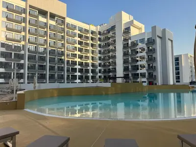 a large swimming pool in the middle of a building at Elegant Retreat Studio in Azizi Mirage in Dubai