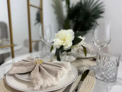 a table with a plate with a napkin on it at Elegant Retreat Studio in Azizi Mirage in Dubai