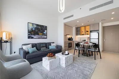 a living room with a couch and a table at Bright & Stylish 1BR in Park Field, Dubai Hills Estate in Dubai