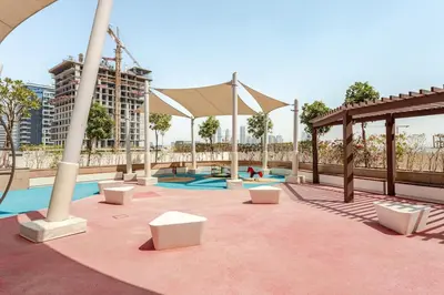 a playground with a pool and a pavilion at Stylish Studio near Downtown with pool in Dubai