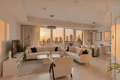 a living room with white furniture and a view of the city at Stunning 2 Bedroom Apartment in Dubai Marina in Dubai