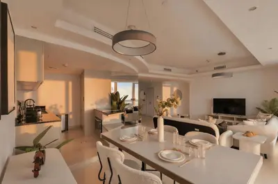 a dining room and living room with a table and chairs at Stunning 2 Bedroom Apartment in Dubai Marina in Dubai