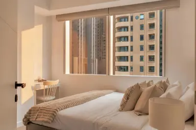 a bedroom with a bed with a large window at Stunning 2 Bedroom Apartment in Dubai Marina in Dubai