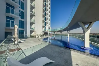 a view of a building with a swimming pool at High-Floor Studio with Views of Miracle Garden and Community, Near Dubai Top Attractions, Skyz by Danube, Arjan by Deluxe Holiday Homes in Dubai