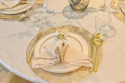 a table with a plate with a napkin on it at Luxury Urban Living at Imperial Avenue, Downtown in Dubai