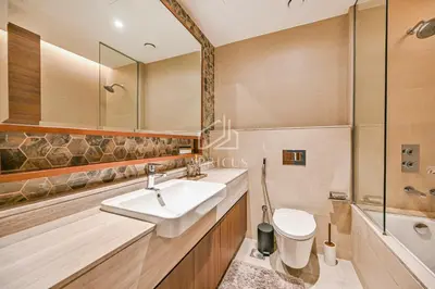 a bathroom with a sink and a toilet and a shower at Luxury Urban Living at Imperial Avenue, Downtown in Dubai