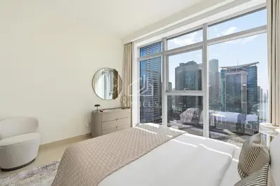 a white bedroom with a large window with a city view at Luxury Urban Living at Imperial Avenue, Downtown in Dubai