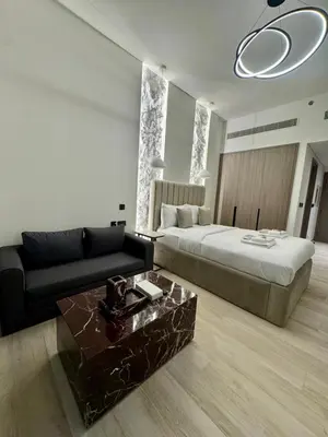 a hotel room with a bed and a couch at Restay Homes at Oxford Gardens - Great City Escape - Swimming Pool Access in Dubai