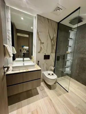 a bathroom with a tub and a toilet and a shower at Restay Homes at Oxford Gardens - Great City Escape - Swimming Pool Access in Dubai