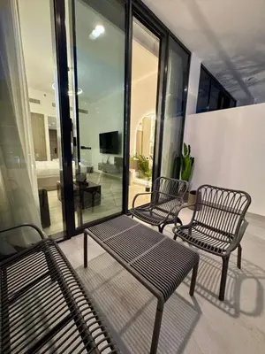 two chairs and a bench on a balcony at Restay Homes at Oxford Gardens - Great City Escape - Swimming Pool Access in Dubai