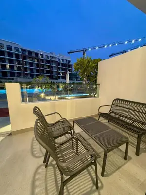 two chairs and a table on top of a balcony at Restay Homes at Oxford Gardens - Great City Escape - Swimming Pool Access in Dubai