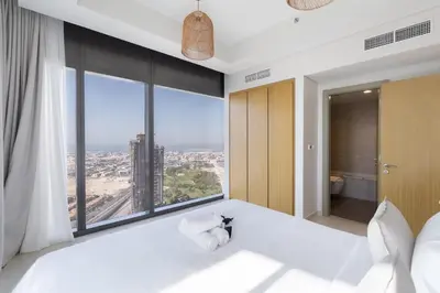 a bedroom with a large window with a view of the city at StayShort - Elegant 2 BR in Business Bay with Amazing Views that sleeps 5 in Dubai