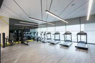 a gym with a row of treadmills and machines at StayShort - Elegant 2 BR in Business Bay with Amazing Views that sleeps 5 in Dubai
